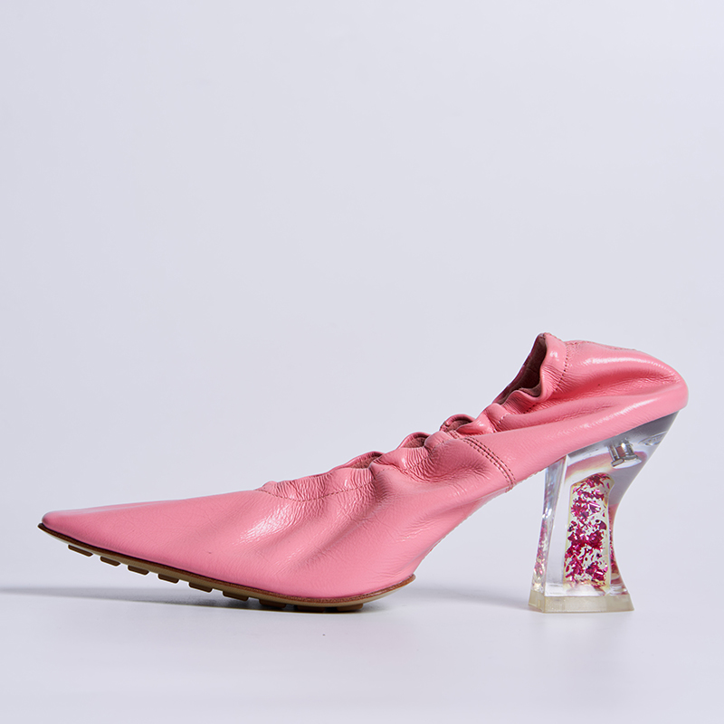 Fashion-forward women’s heel with gathered leather upper and sculptural transparent heel for statement designer collections