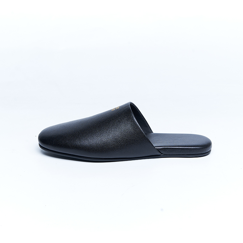 Black leather mule with minimalist upper and open-back construction, suitable for contemporary designer footwear brands