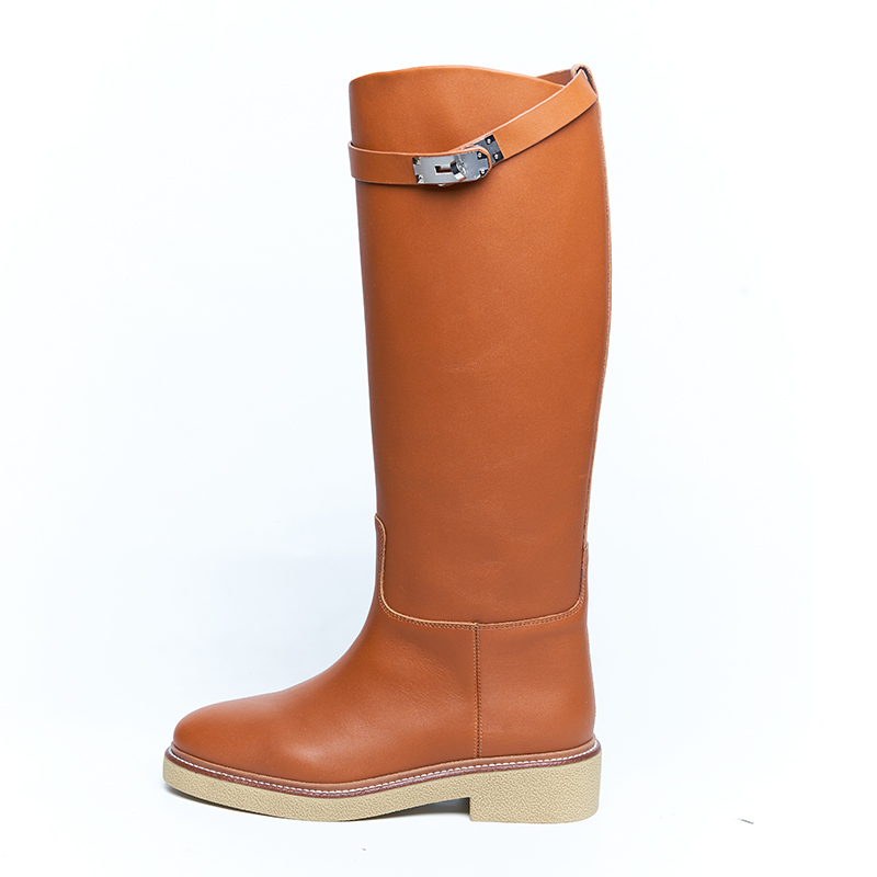 Brown leather riding boots with strap detail and flat sole, developed for designer brands OEM ODM