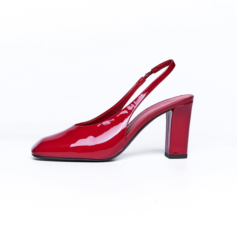 Sculptural slingback high heel with glossy leather finish and bold block heel designed for contemporary designer brands
