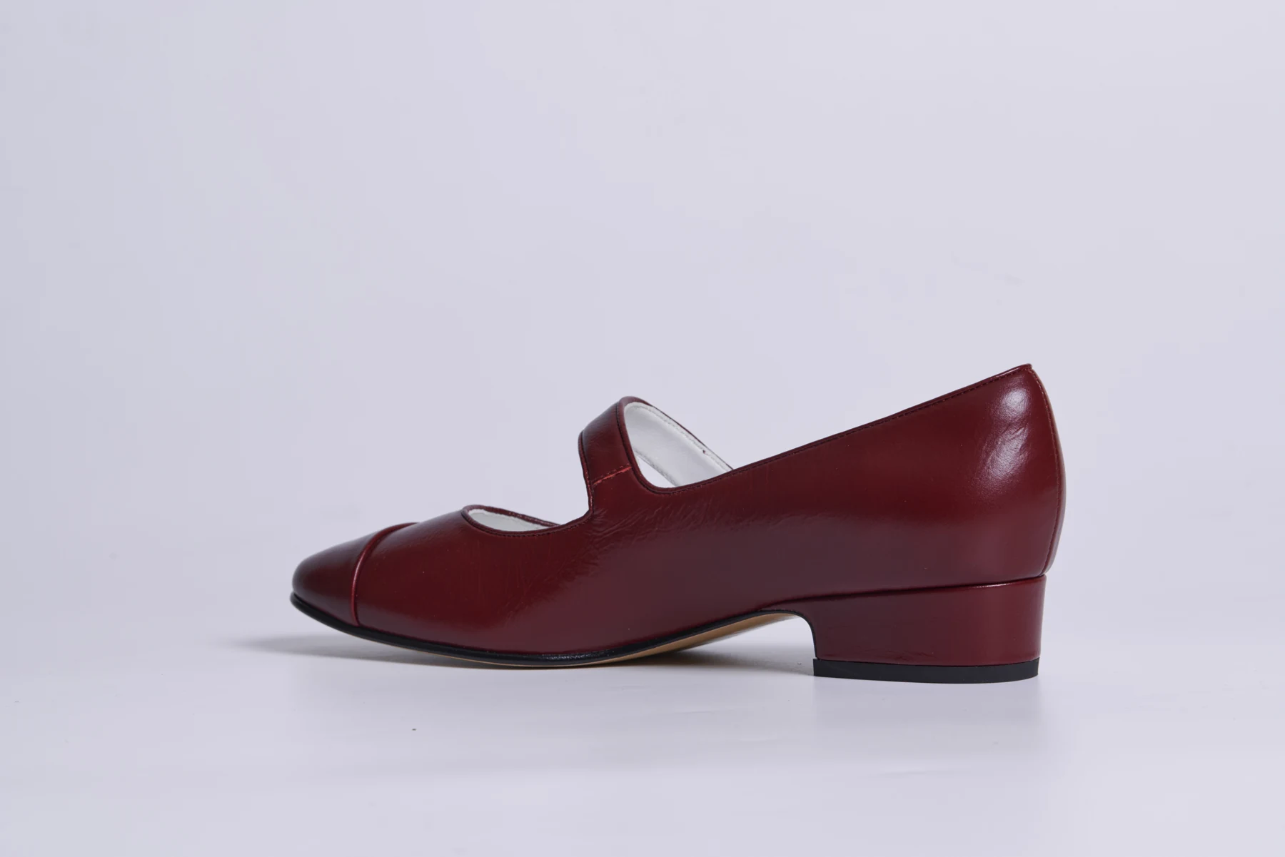Burgundy women's dress shoe presented in profile