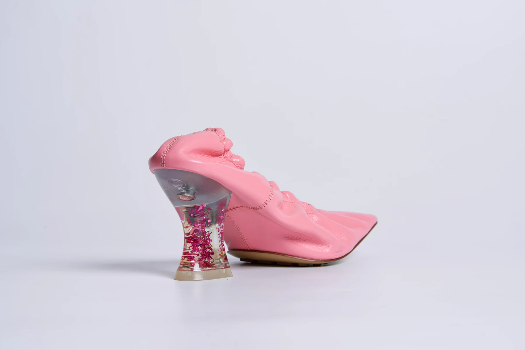 Pink sculptural statement heel on a clean studio background